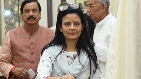 TMC Mahua Moitra dressed  in a white suit, participating in the Vice President election in India, placing her vote in a blue ballot.