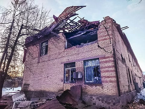 The image shows a damaged house, destroyed by Russian drone strikes in Ukraine.