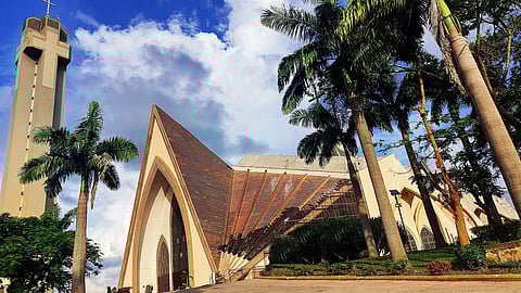 The National Christian Centre, a popular place of worship for Christians in Nigeria. It is a large cathedral with a tower topped with a cross next to it.