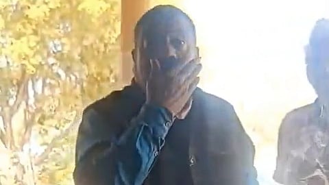 A screenshot of a video showing BJP leader Ashok Singh from Satna, MP, threatening a rape survivor.