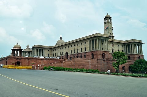 Ministry of Home Affairs building building with a grand facade, red sandstone base, and domed towers under a partly cloudy sky, evoking a sense of authority.