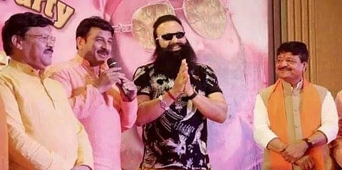 The image shows Gurmeet Ram Rahim with Manjoj Tiwari and Kailash Vijayvargiya