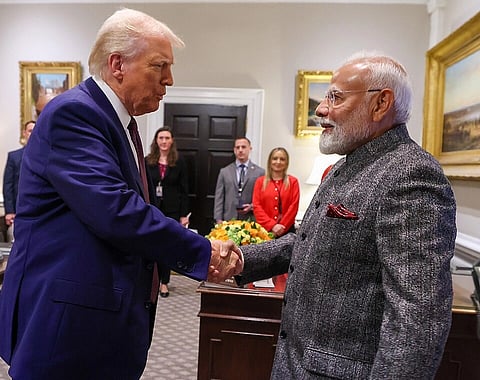  PM meets the President of USA, Mr. Donald Trump at White House in Washington DC, USA on February 13, 2025. The two are seen shaking hands while people in the background watch.