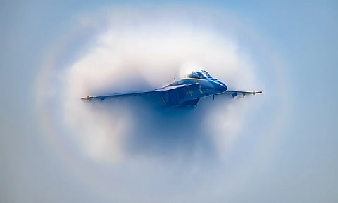 Image of  F/A-18 Hornet with condensation clouds from shockwaves