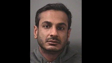 A portrait of the arrested accused Arsalan Chaudhary wearing a grey hoodie, with a sad expression. 