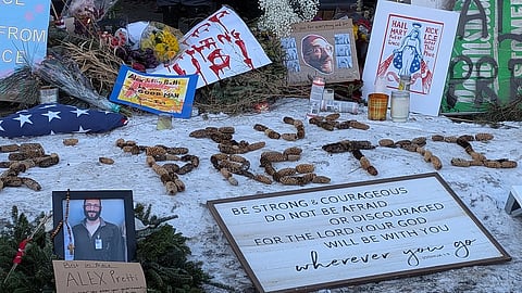 A photo of some of the items left at the site of Alex Pretti's death. Alex Pretti is spelt out.