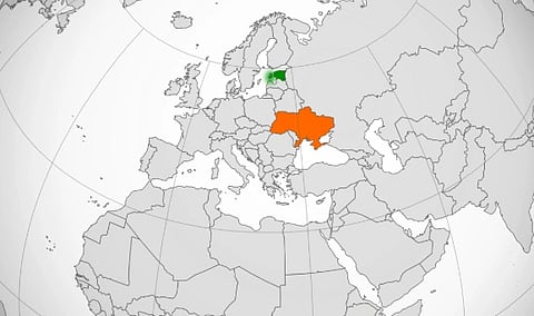 Map highlighting Finland in green and Ukraine in orange, set against a grey-scale depiction of Europe, emphasizing geographical location.