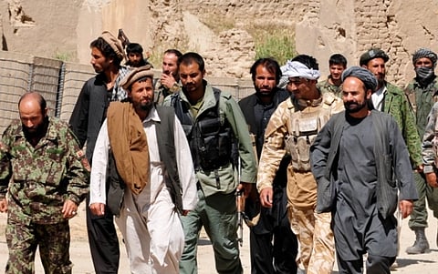 Image of Taliban insurgents turn themselves in to Afghan National Security Forces at a forward operating base in Puza-i-Eshan. Their defections come in the midst of Operation Taohid II, and Afghan-led operation designed to defeat the insurgency.