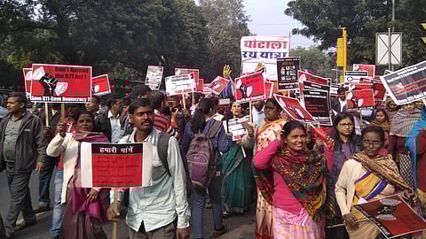 A protest against amendments to the RTI Act in 2018. Many people are gathered raising placards saying 'don't amend the RTI act'.