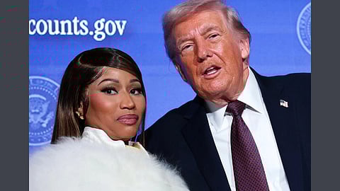 In the image President Donald Trump and Nicki Minaj is shown looking at the camera behind them is  a US government backdrop