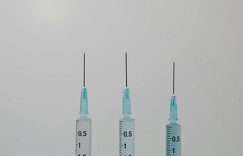 Image of three syringes held upwards. 