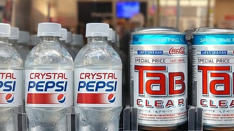 Vending machine shelves with clear Crystal Pepsi bottles on the left and Tab Clear cans on the right. Bright lighting gives a vintage feel.