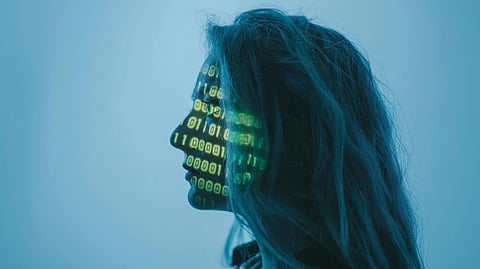 Silhouette of a person facing left with green binary code projected on their face. The background is a calming blue, evoking a futuristic, digital theme.