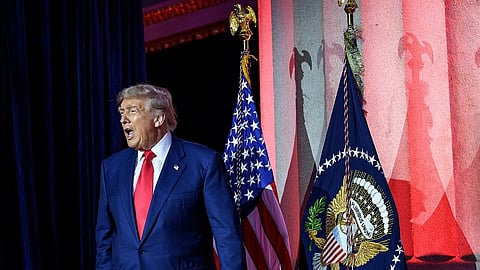 President Donald Trump arrives to the White House AI Summit at Andrew W. Mellon Auditorium in Washington, D.C., Wednesday, July 23, 2025. He is wearing a blue suit, the US flag is behind him.