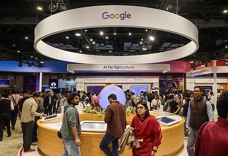 A busy trade show booth features Google's "AI for Agriculture" display. Attendees walk around, engaging with the technology, creating a lively atmosphere.