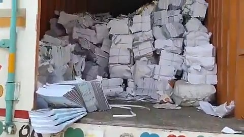 Bundles of textbooks piled up in a truck.