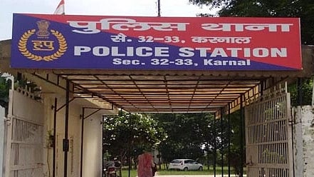 Front entrance of Sector 32-33 police station, Karnal, with a blue and red board above.