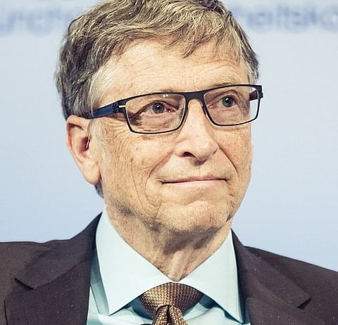 Image of Bill Gates Co-founder of Microsoft. He is wearing a blue shirt and is in a suit with his glasses. The picture is taken during the Munich Security Conference 2017