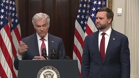 D Vance and Mehmet Oz stand in front of an american flag, behind a podium.