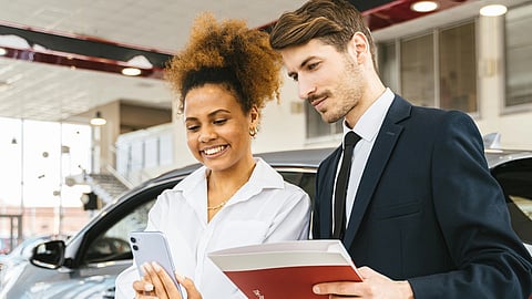 In the image two person are shown talking to each other for marketing