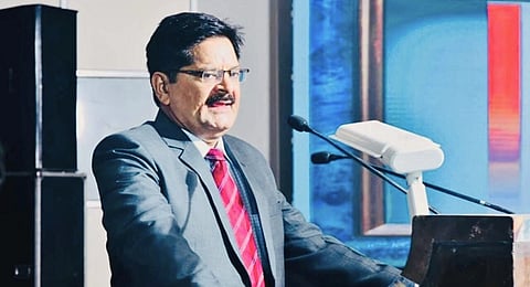 Ratanlal Mund, a retired special judge in the POCSO court, speaking at a podium