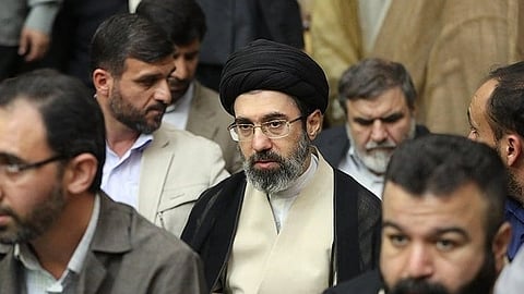 Mojtaba Khamenei sitting surrounded by men