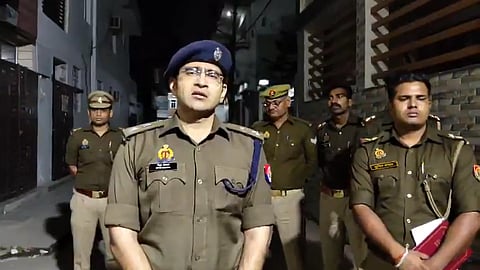 DCP of South Lucknow speaking to the camera with officers standing behind him