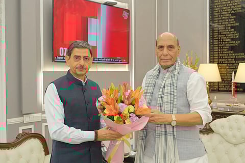 RN Ravi and Defence Miniser Rajnath Singh. Singh is presenting a bouquet of flowers to Ravi