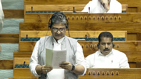Congress MP Mohammad Jawed standing in Lok Sabha, reading from papers.