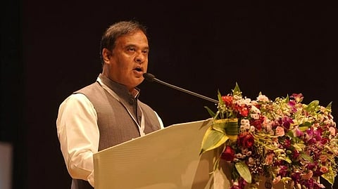 In the image Hemanta Biswa Sarma is shown adressing people in the podium 