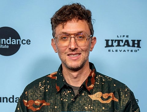 Image of director David Borenstein from the 2025 Sundance Film Festival Awards. he is holding an award in his hands. 