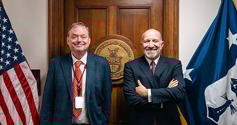 Kevin Hassett, Director of the White House National Economic Council (left), Howard Lutnick (Secretary, U.S. Department of Commerce), both wearing suits, us flag behind
