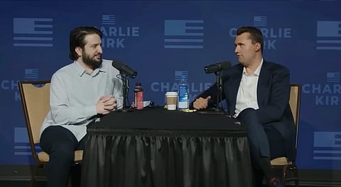 In the image Charlie Kirk with Ex-Muslim Ridvan Aydemir in Turning Point USA Stage they are having a conversation