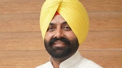 In the image ex minister of Punjab Bullar is shown smiling wearing yellow turban