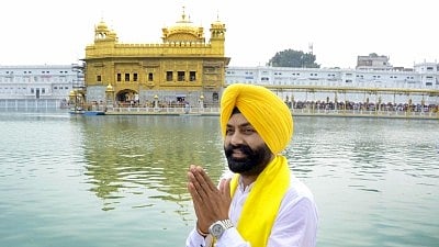 In the image ex minister bhullar is shown joining his hands in front of golden temple
