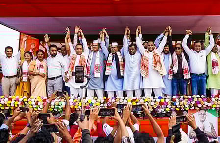 Barpeta: Assam Congress President Gaurav Gogoi joins hands with leaders during a public meeting in support of Congress candidate Abdur Rahim Ahmed for the Assam Assembly elections, at Bamundongra in Chenga constituency of Barpeta district on Wednesday, March 25, 2026. (Photo: IANS/X/@INCAssam)