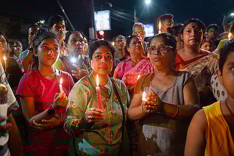Women and some men in the background stand with candles during a protest march for the R.G. Kar Hospital Rape and Murder 2024.