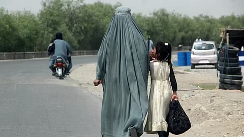 In the image a girl from afghanistan is shown wearing burkha going with a girl 