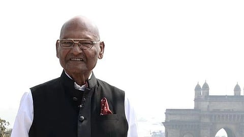 Anil Agarwal smiling infront of a monument