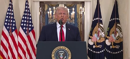 A man standing in front of the Podium speaking. 