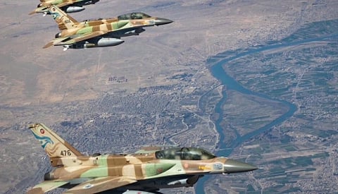 Image of Israeli Air Force F-16I Sufa fighter jets, Operation Roaring Lion 2026. Four camouflaged fighter jets flying in formation over a desert landscape with a winding blue river below, conveying precision and coordination.