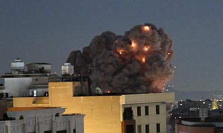 In the image a black smoke is shown above a building