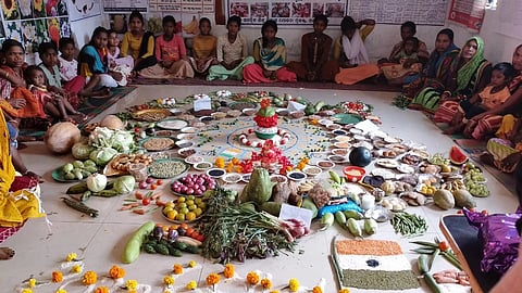 children sat around a mat in a classroom filled with food