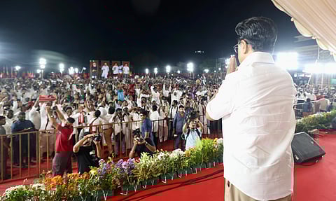 In the image MK Stalin is shown joining hands to the crowd of public who are attending the rally