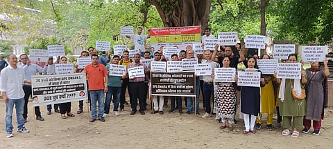 Parents of students enrolled at DPS Dwarka, Salwan School, Birla Vidya Niketan, Srijan School and many other schools participating in a silent protest outside Directorate of Education (DoE) on March 31, 2026, following their childrens’ names struck off by the schools