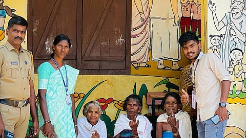 In the image three old lady are showing showing their finger indicating voting while two other officers and a police officer is shown
