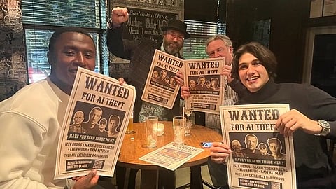 Four people in a cozy bar hold up "WANTED FOR AI THEFT" posters with smiles and playful expressions. The atmosphere is lighthearted and humorous.