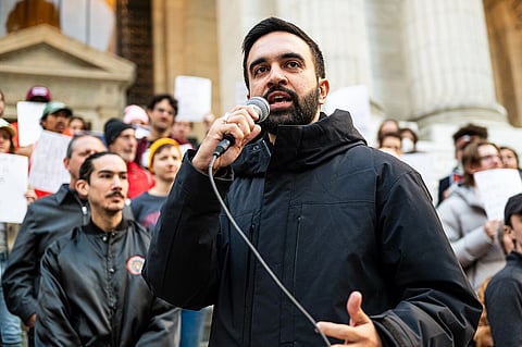photo of NYC Mayor Zohran Mamdani speaking to a microphone at a public rally