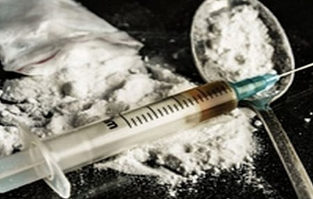 An Injection with a spoon and powder, resembling drugs