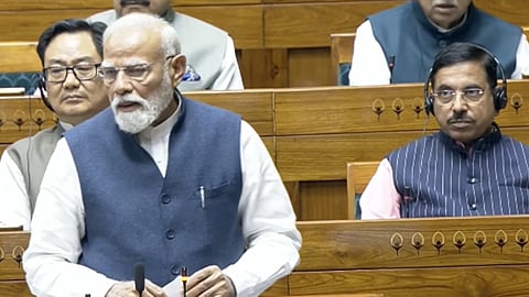 Narendra Modi speaking in Lok Sabha with papers in hand